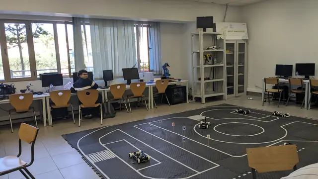 A lab with a black foam-tile track marked with white lane lines.
