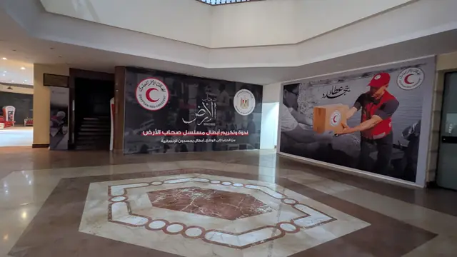 A marble lobby with a large Red Crescent mural.