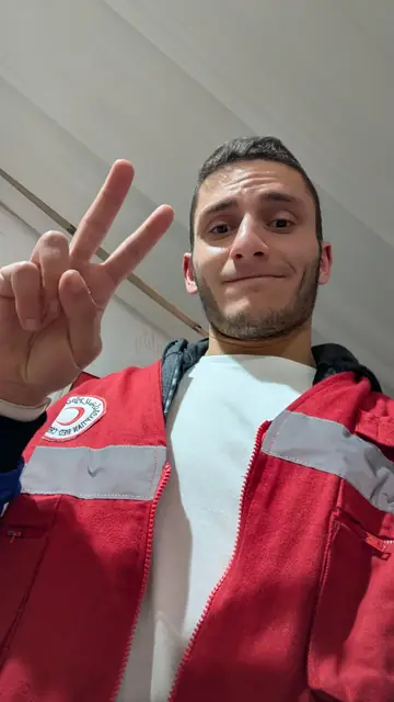 A selfie in a red Egyptian Red Crescent volunteer jacket.