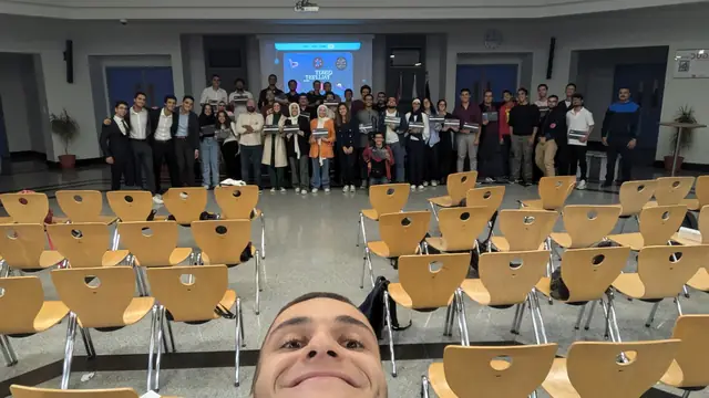 A selfie in front of the whole Qiskit Fall Fest 2024 group, holding certificates.