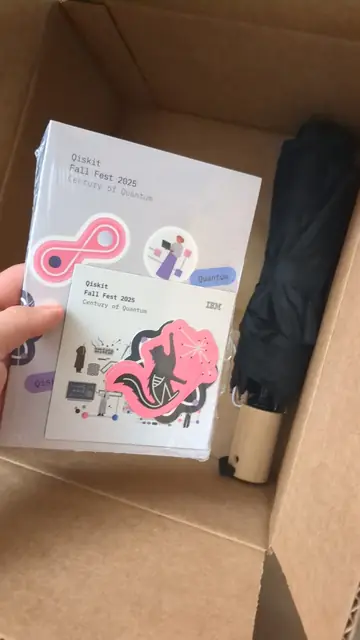 A Qiskit Fall Fest 2025 notebook and stickers in an opened box.