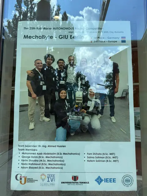 The MechaByte team poster in a glass case, listing the supervisor and team members.
